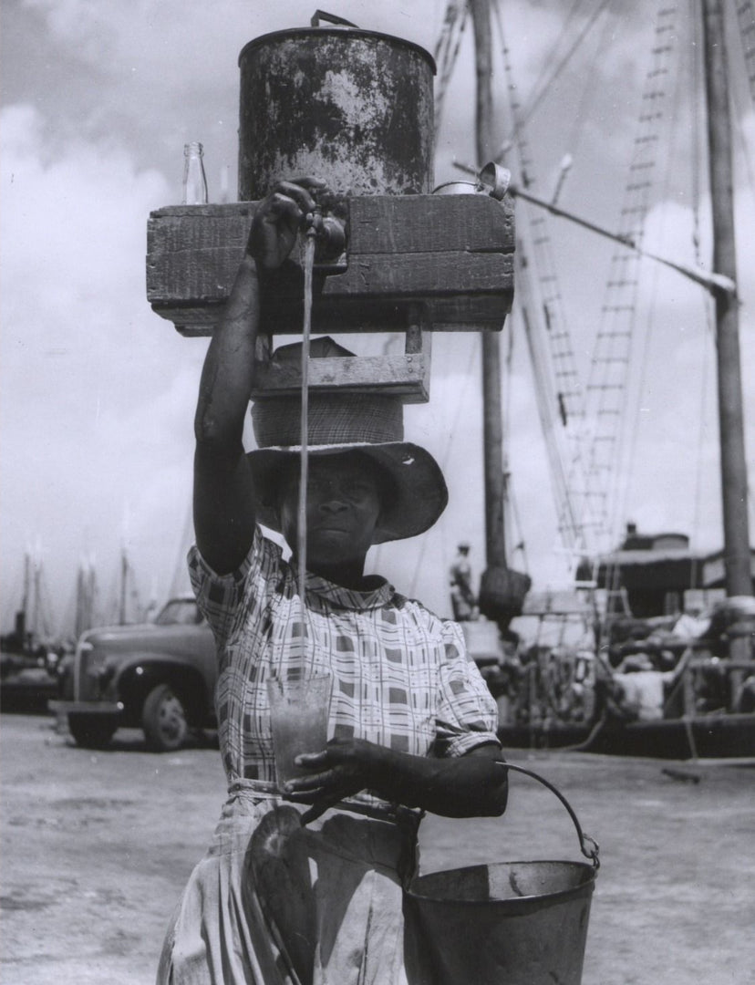 Mauby Woman pouring drink from the head